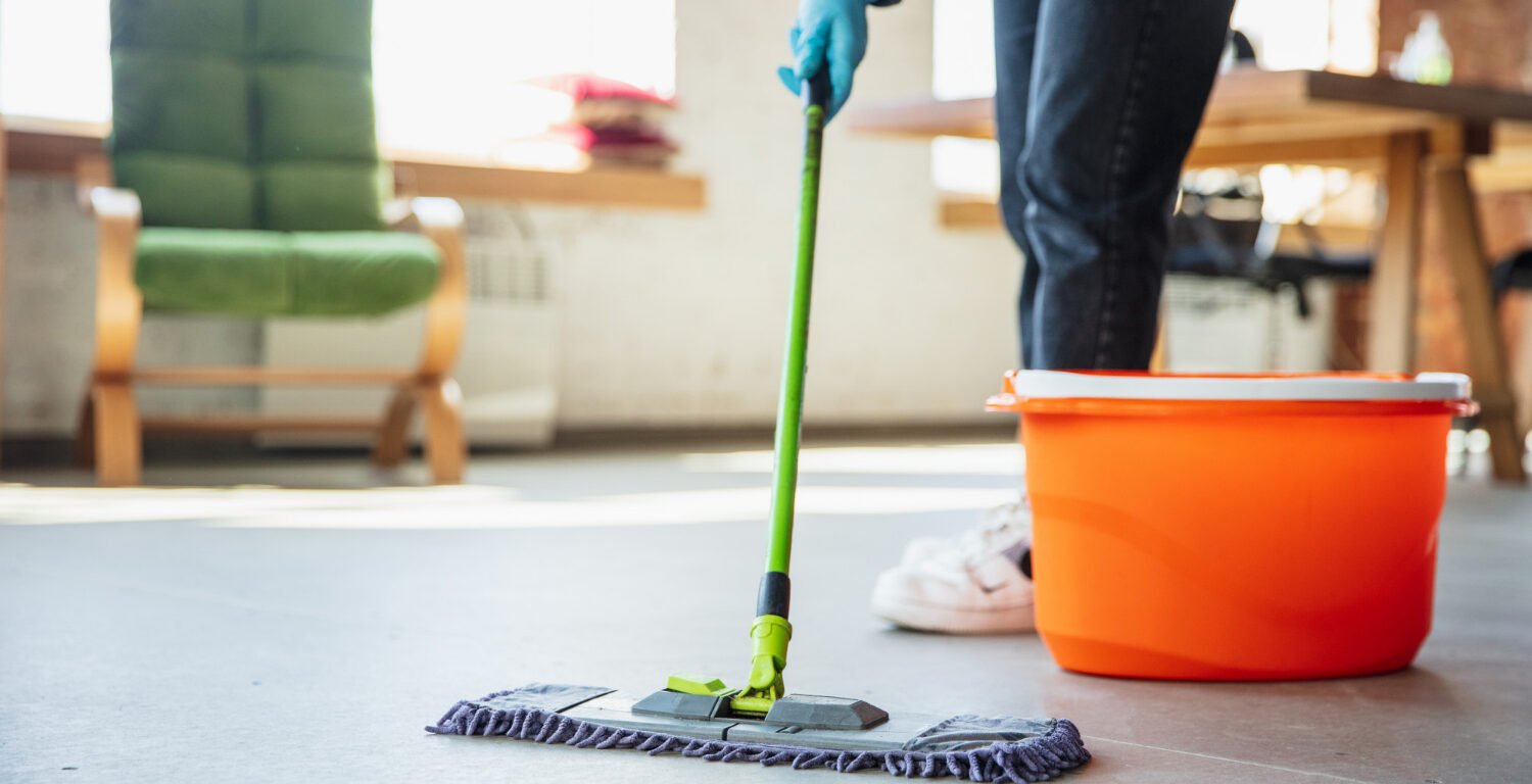 A cleaner moping the floor.
