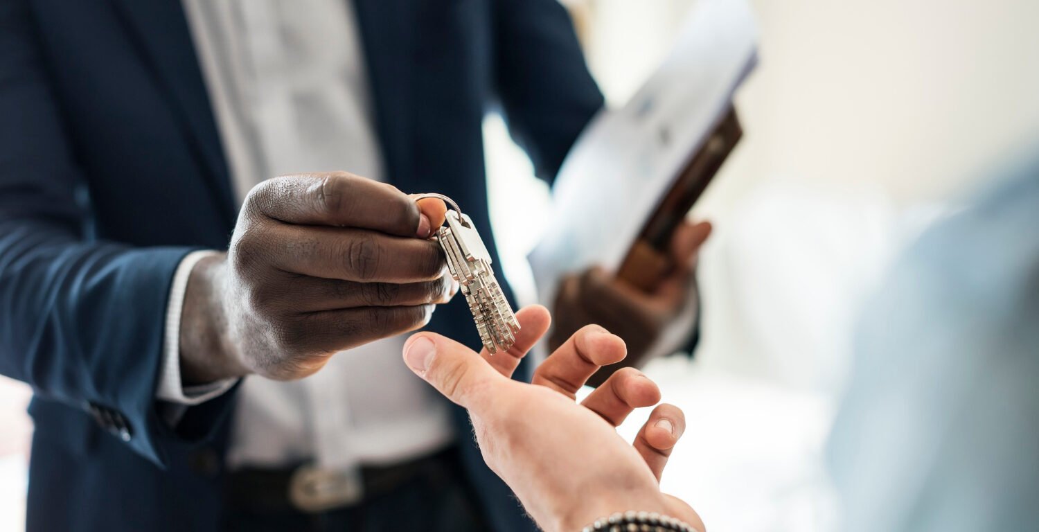 real estate agent handing house keys to a client