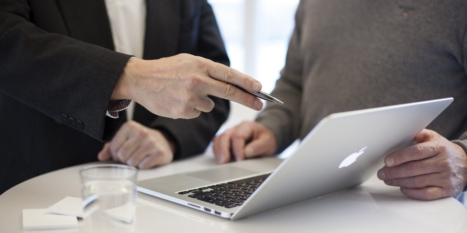 Two men looking at a laptop.